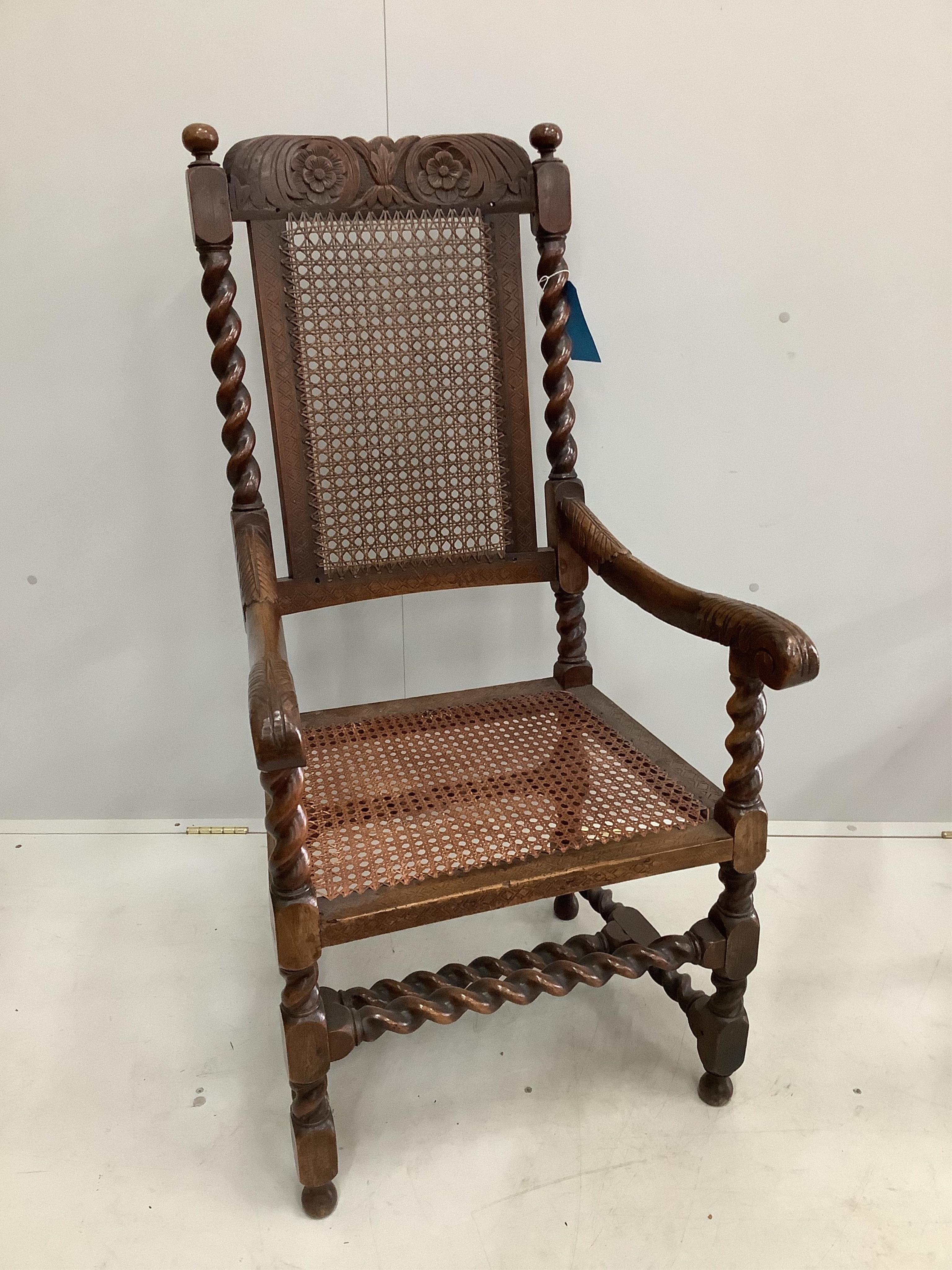A William and Mary walnut and caned seat and back armchair, with a pierced scrolling crest rail and arched pierced front stretcher, width 56cm, depth 54cm, height 116cm. Condition - fair